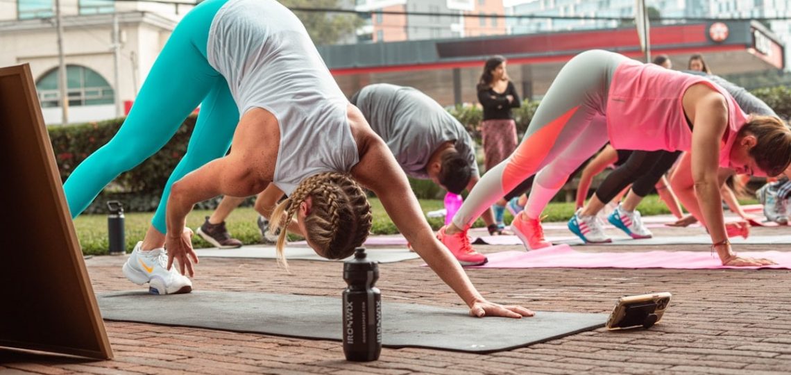 a group of people doing yoga on a brick floor